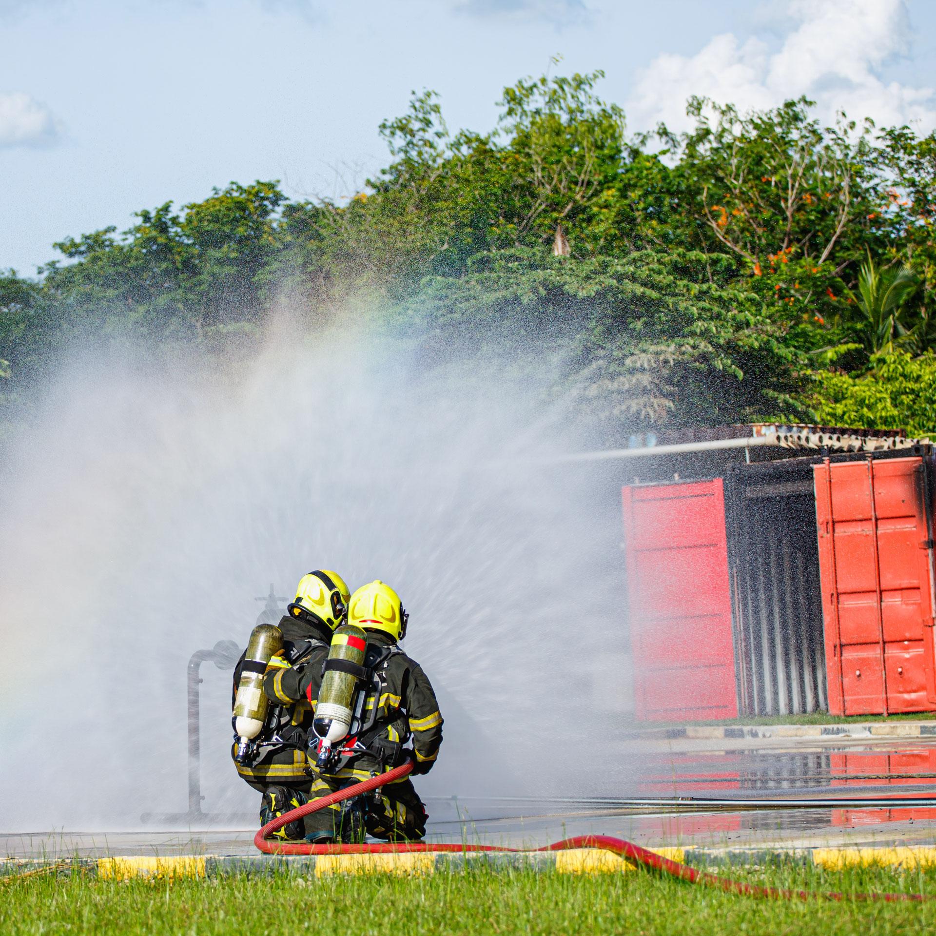 Fire technology students using a firehose